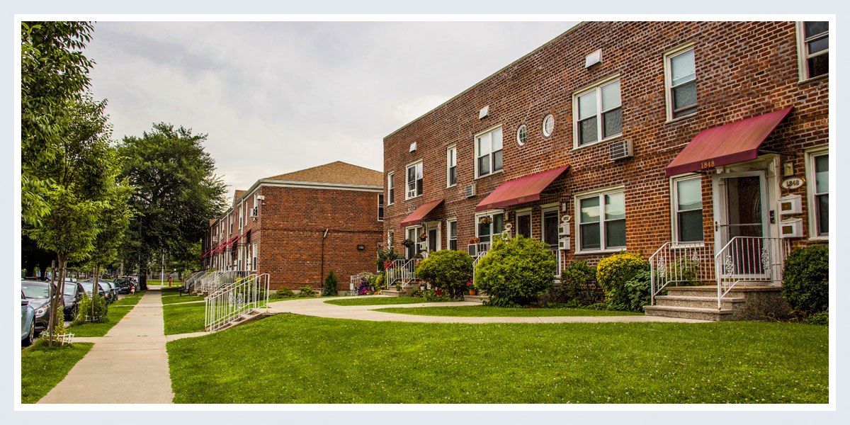 a row of brick apartment buildings on a city street