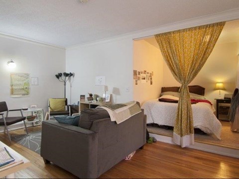 a living room with a couch and a bed