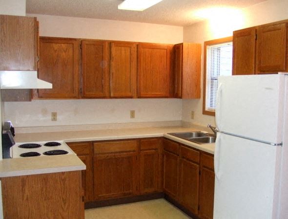 a kitchen with a stove and a refrigerator