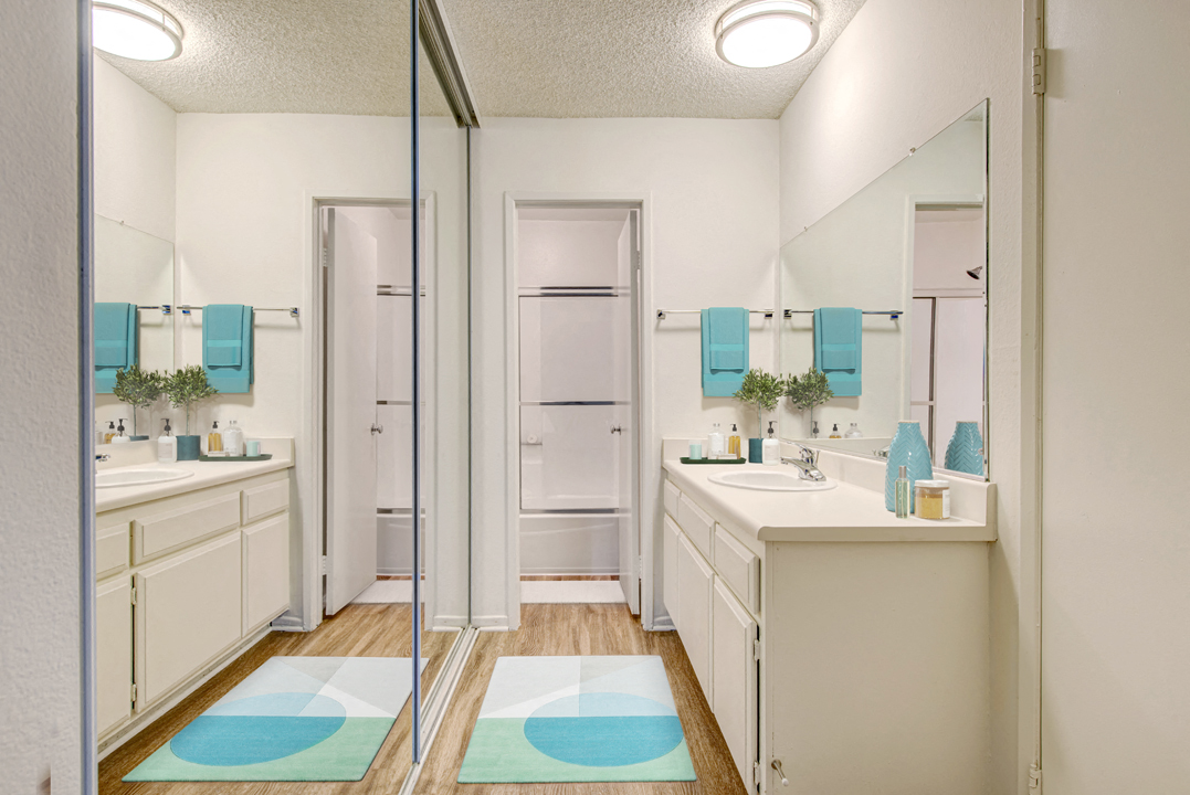 Mirrored wardrobe and bathroom at Village Pointe Apartment Homes