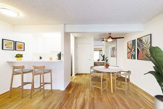 Dining area, kitchen, and living room at Village Pointe Apartment Homes