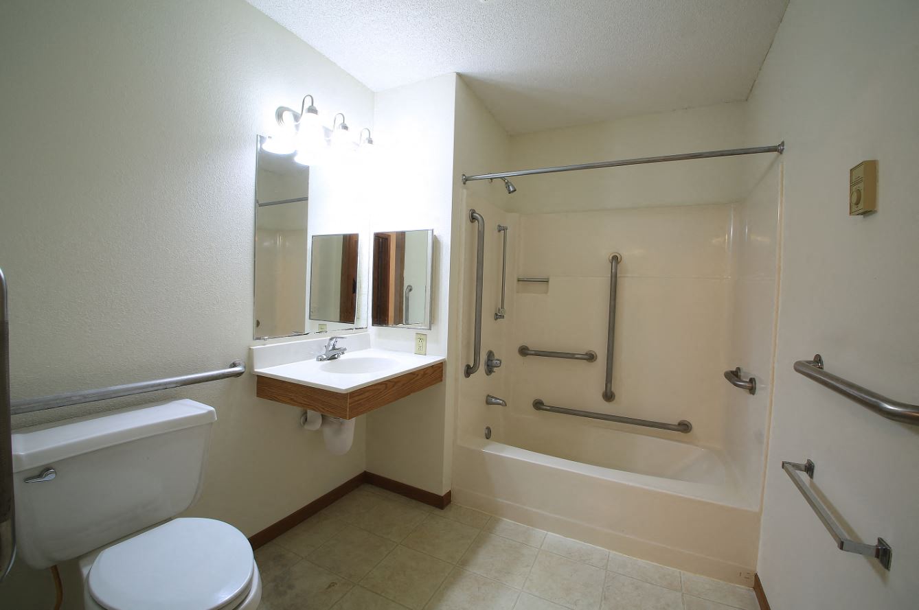a bathroom with a shower and a sink and a toilet