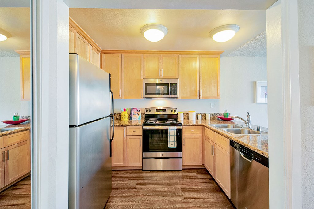 a kitchen with stainless steel appliances and wooden cabinets