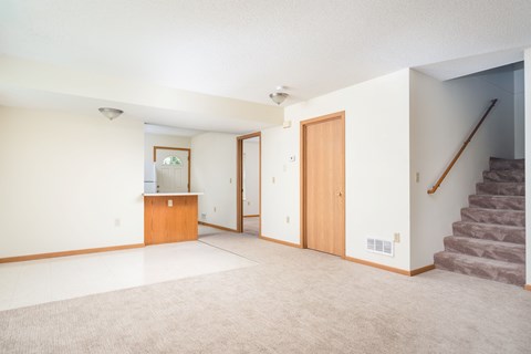 A room with a staircase on the right side.