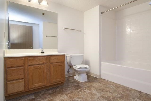 a bathroom with a toilet and a sink and a shower