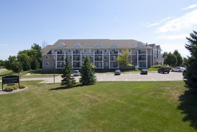 a large building with cars parked in a parking lot