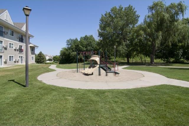 a playground in a park next to a building