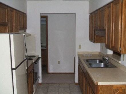 a kitchen with a sink and a refrigerator