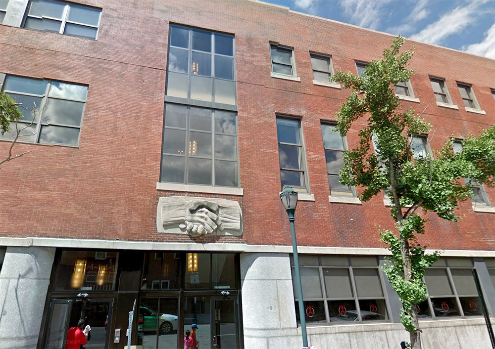 a brick building with a lion statue on the side of it