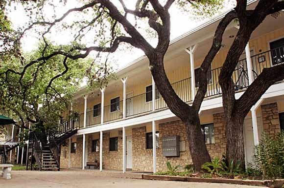 a large building with a tree in front of it