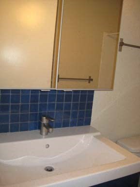 a small bathroom with a sink and a mirror