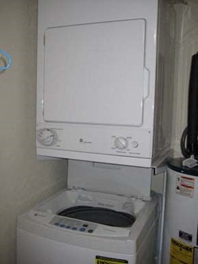 a white toilet sitting on top of a washing machine