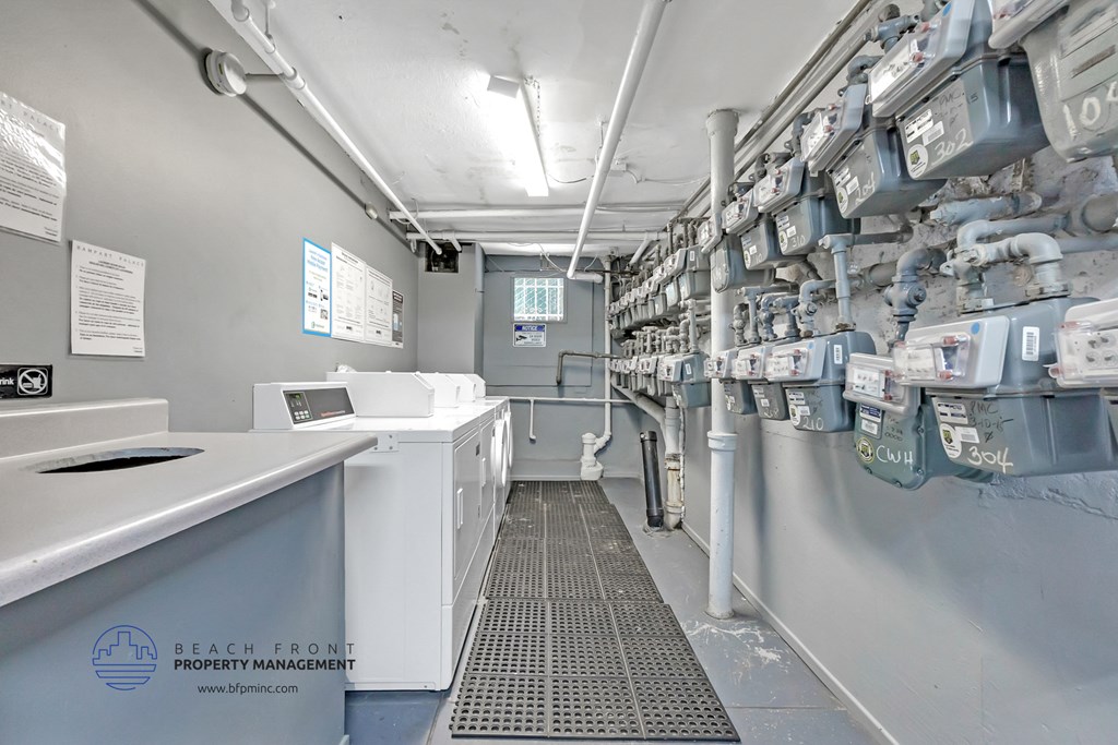 a laundry room with lots of washer and dryer machines