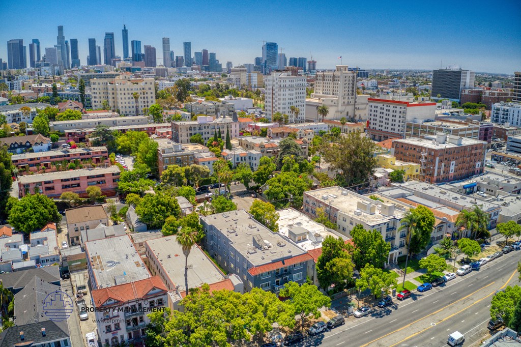 an aerial view of the city with buildings and trees