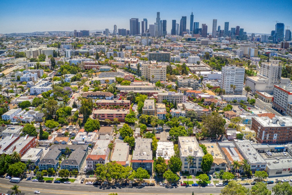 an aerial view of the city with skyscrapers and trees
