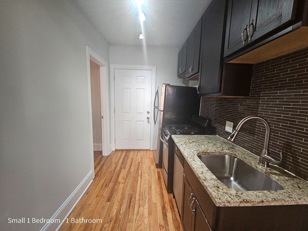 a small kitchen with a sink and a refrigerator