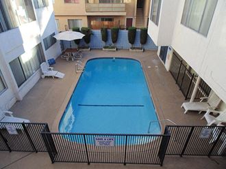 an overhead view of a swimming pool in the middle of a hotel building