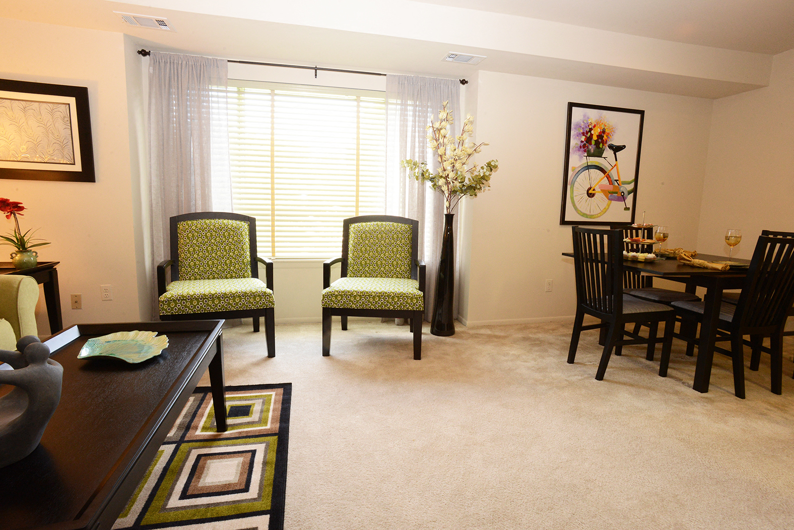 A living room with a dining table and chairs.