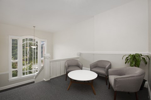 a living room with two chairs and a table