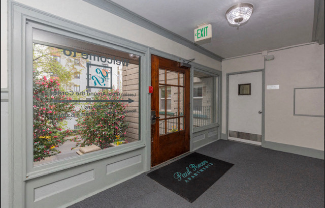 the entrance of a building with a large window and a door