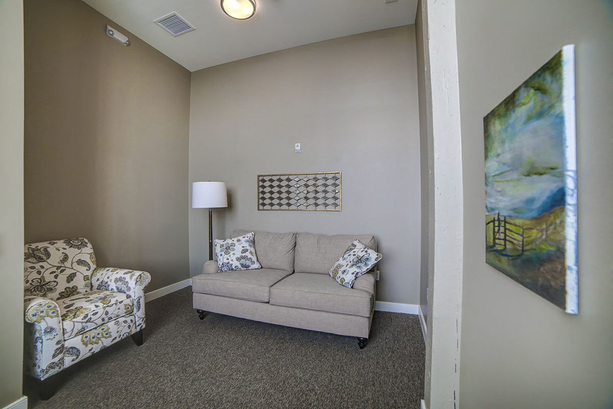 a living room with a couch and a chair