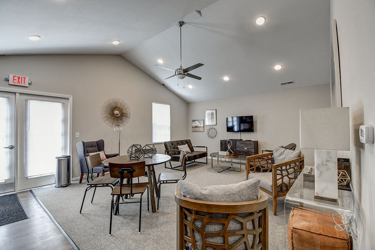 a living room with furniture and a ceiling fan