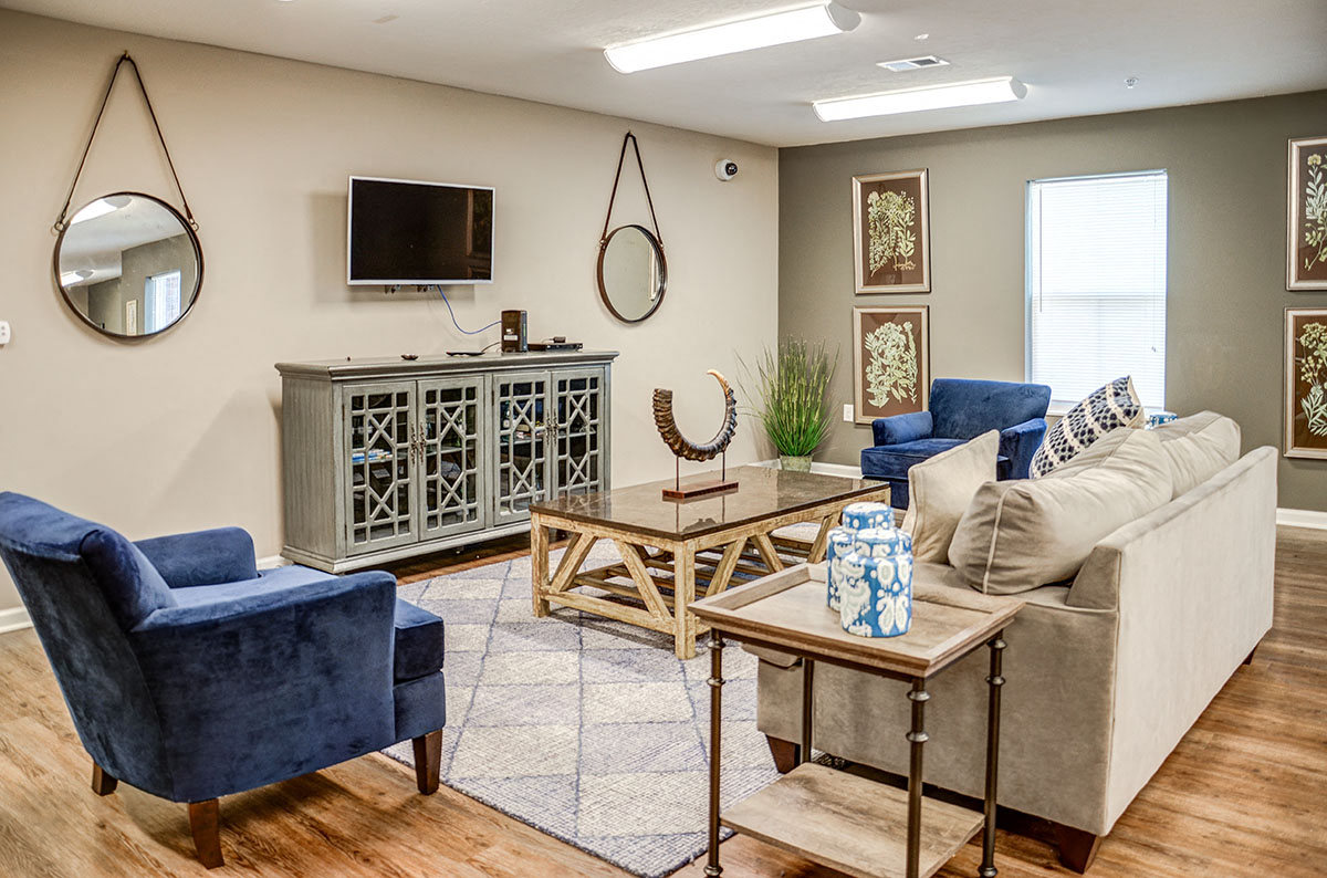 a living room with a couch and chairs