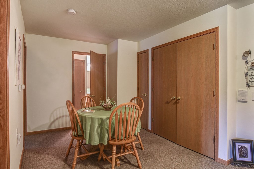 a dining room with a table and chairs