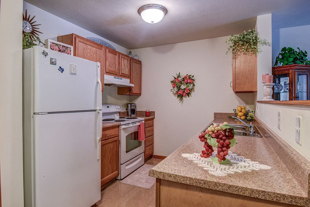 a kitchen with a counter top and a refrigerator