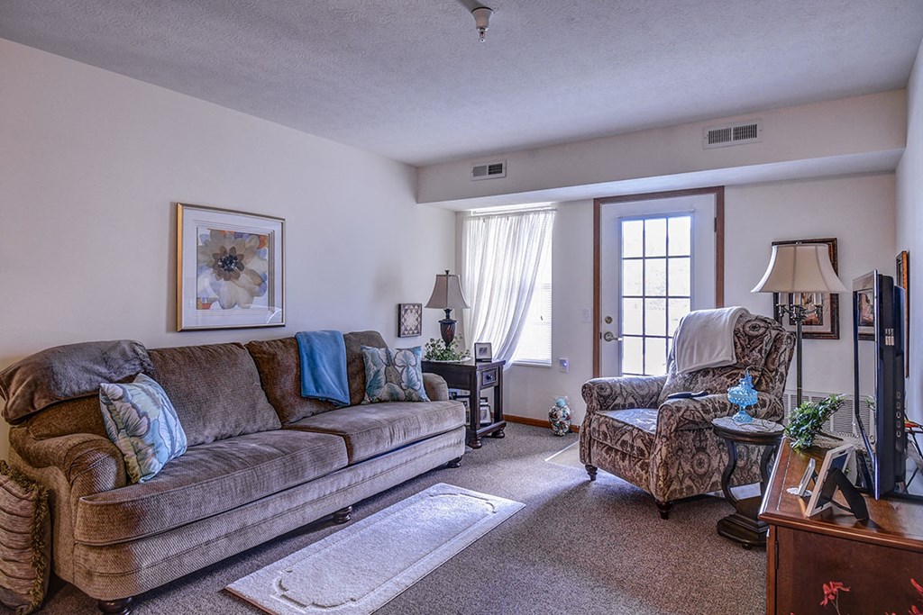 a living room with two couches and a chair and a table