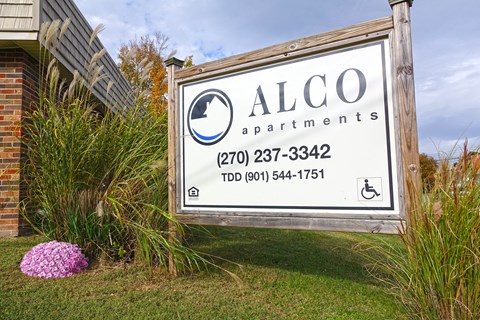 a sign apartments in front of a building