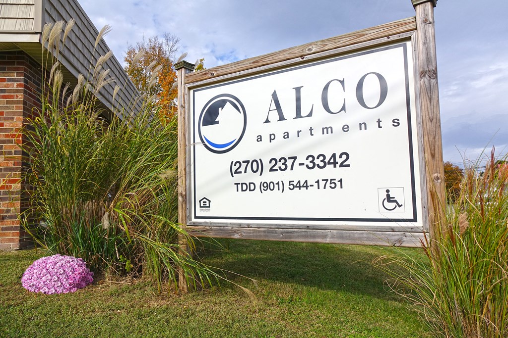 a sign apartments in front of a building