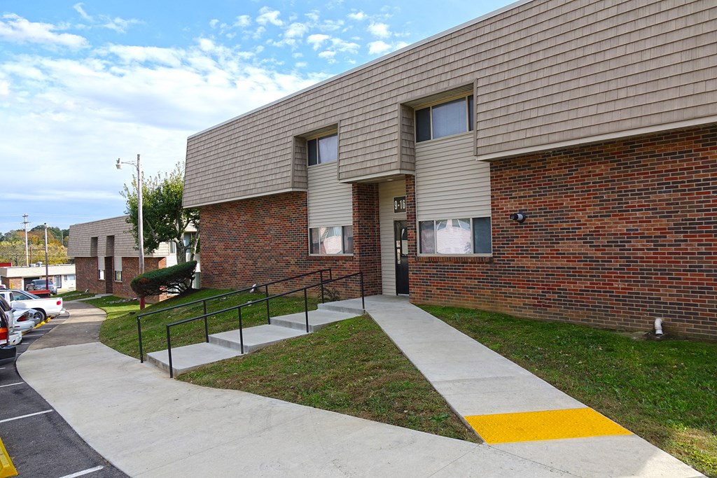 a brick building with a sidewalk in front of it