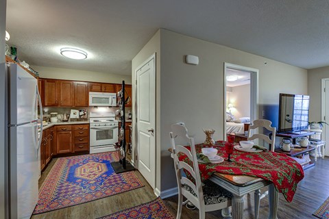 a kitchen and dining room with a table and chairs