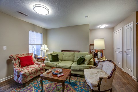a living room with a couch and two chairs