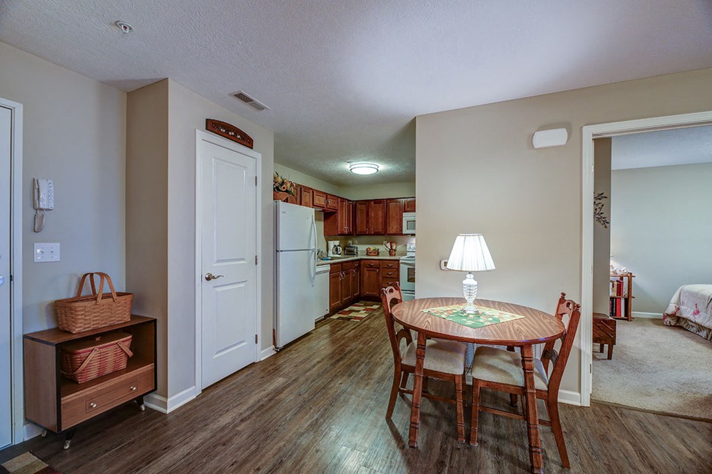 a kitchen and dining room with a table and chairs