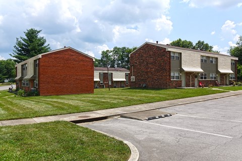 an empty parking lot in front of an apartment building