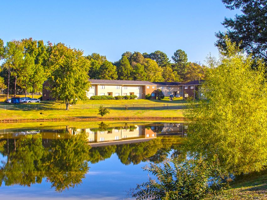 this is a photo of the leasing office and leasing office building from across the pond