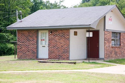 a small brick building with a blue door