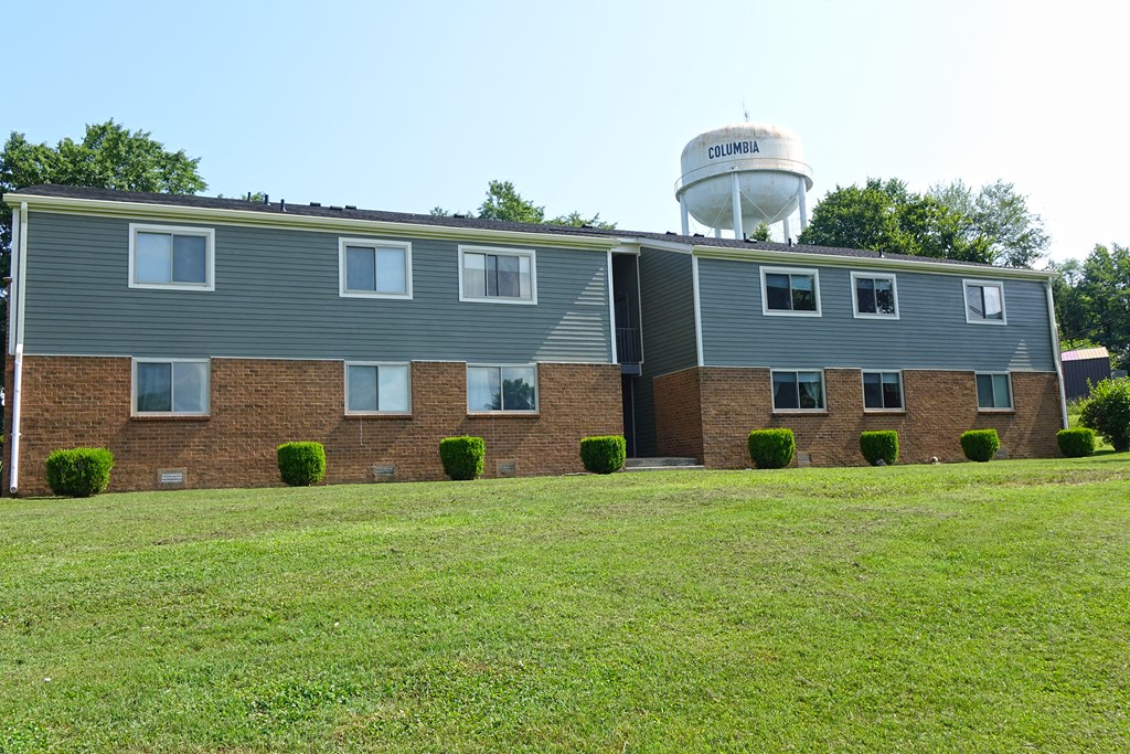 an apartment building with a water tower in the background