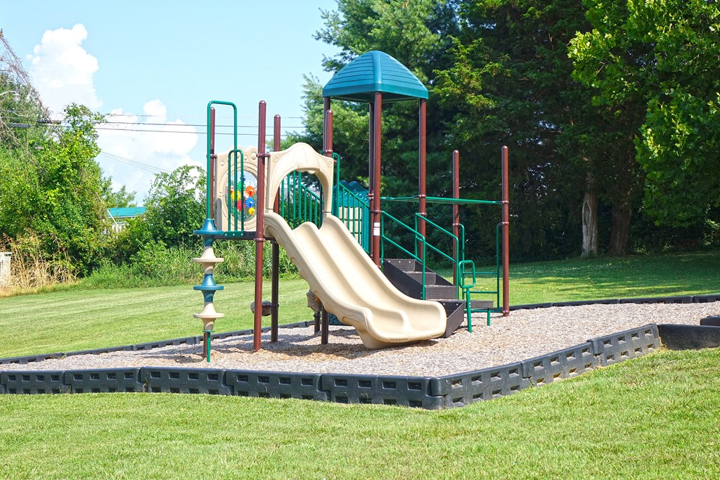 a playground with a slide in a park