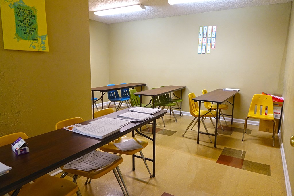 a classroom with tables and chairs and desks