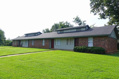 a house with a green lawn in front of it