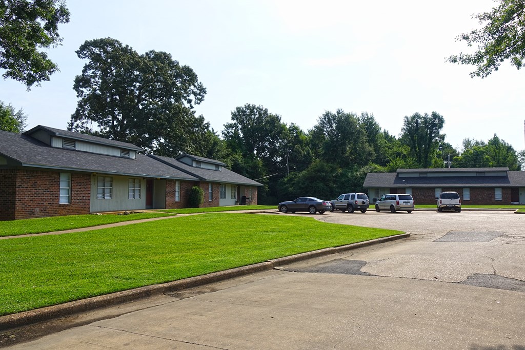 a neighborhood of houses with cars parked in a parking lot