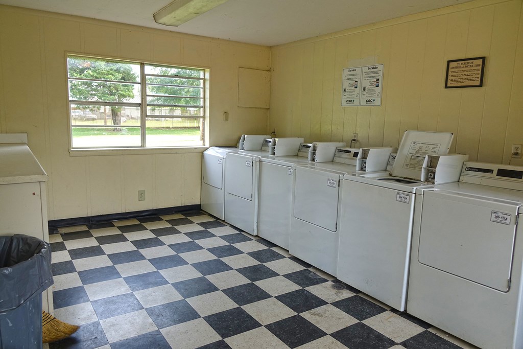 the laundry room is full of washers and dryers