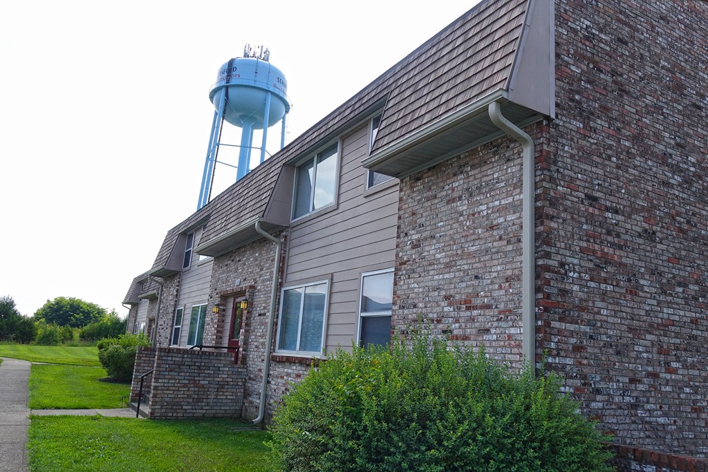 a brick building with a water tower in the background