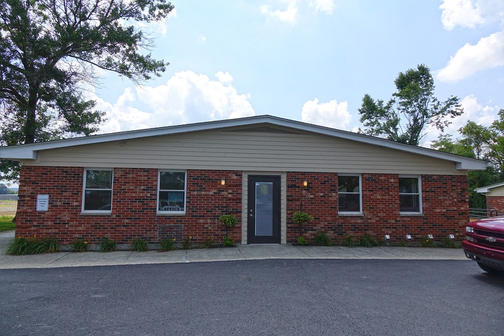 the front of a brick building with a blue door