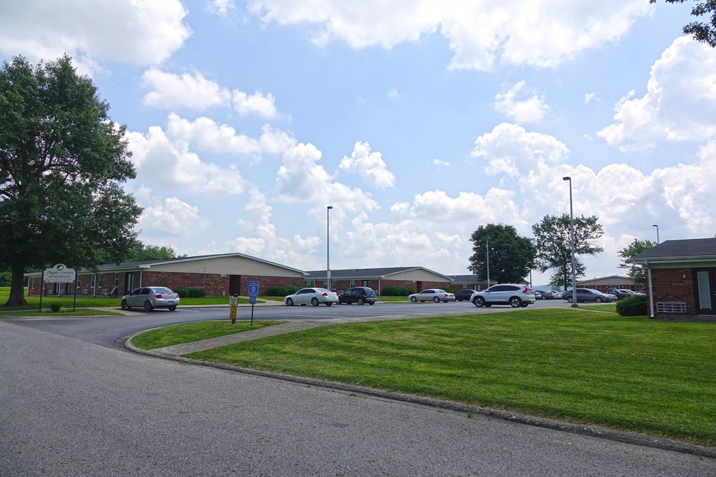 a parking lot with cars parked in front of a building