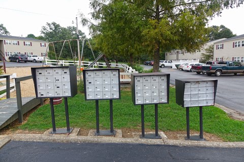 several metal boxes on the side of a street