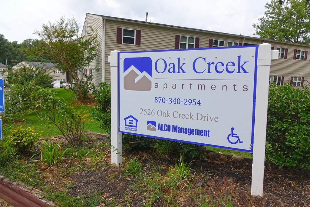 a sign apartments in front of a house